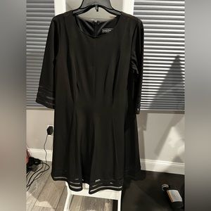 Black dress. Worn once. Sheer lines around arms and hem. Zip back.